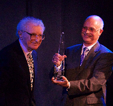 Daniel handing Sheldon Award